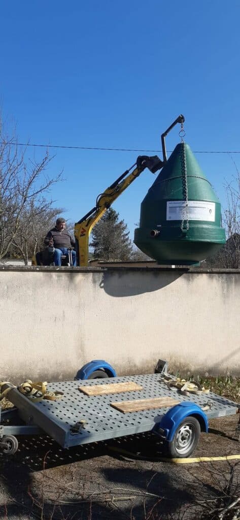 Christian Cach soulève une micro-station Diamond par-dessus un muret